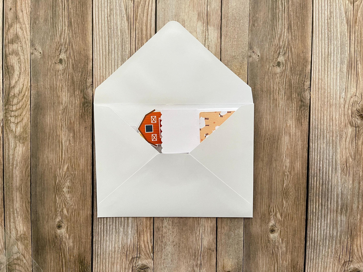 White envelope with a card on a wooden surface