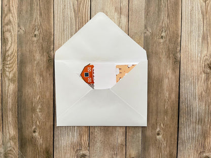 White envelope with a card on a wooden surface