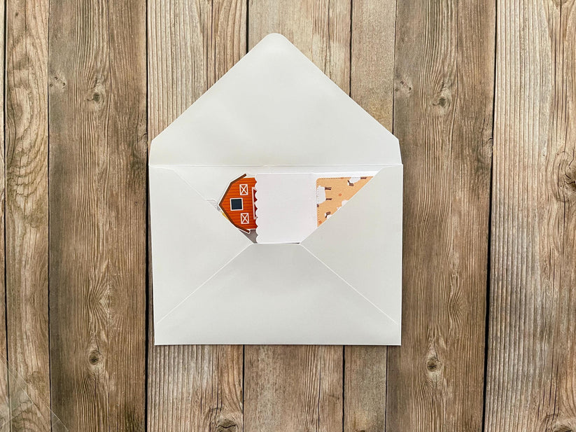 White envelope with a card on a wooden surface