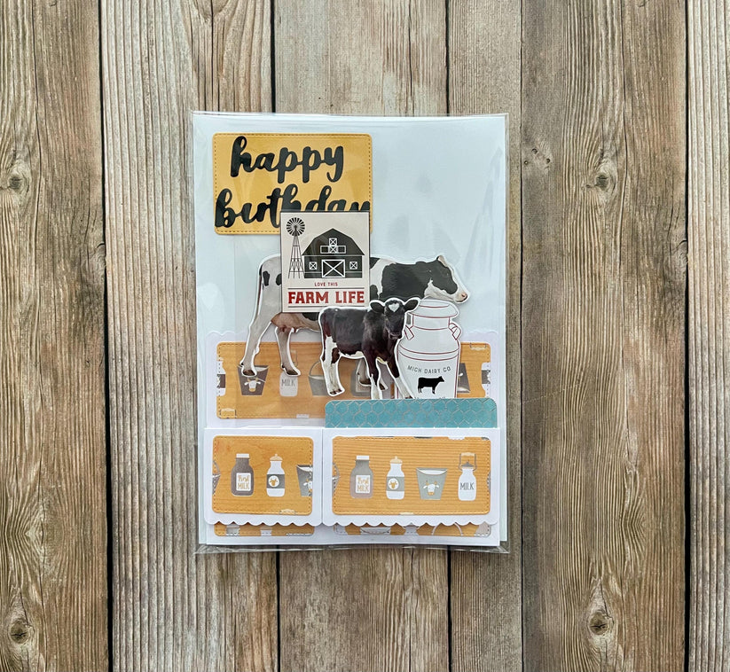 Birthday card with farm-themed illustrations on a wooden surface