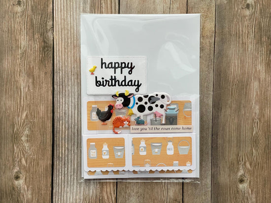 Birthday card with farm-themed illustrations on a wooden surface