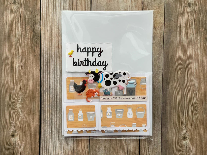Birthday card with farm-themed illustrations on a wooden surface