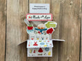 Pop-up  Mother's Day card with a baking theme, 'Made with Love' message and "Whisking you a Happy Mother's Day" on a wooden background