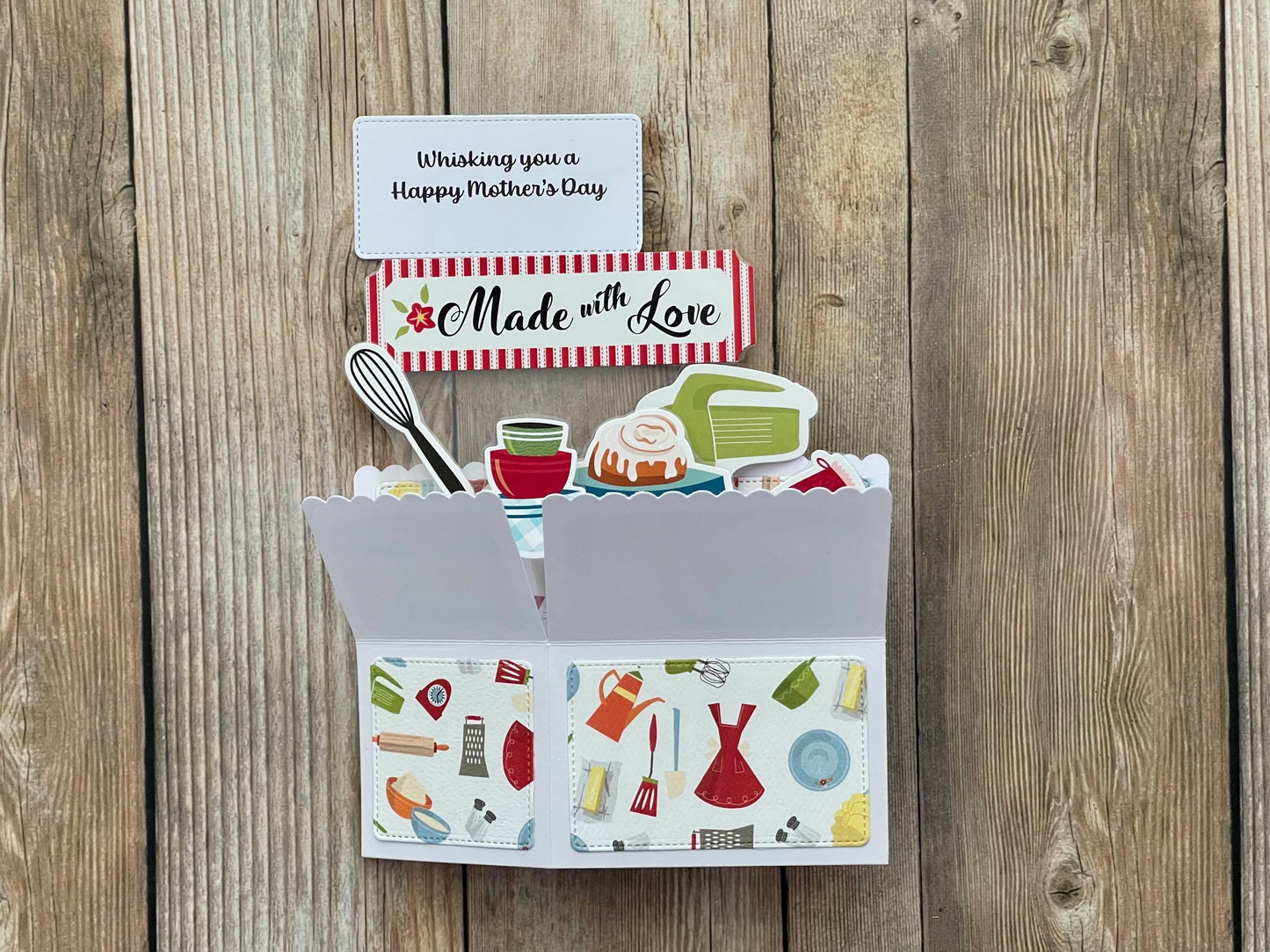 Card with cooking-themed illustrations and a 'Happy Mother's Day' message on a wooden background
